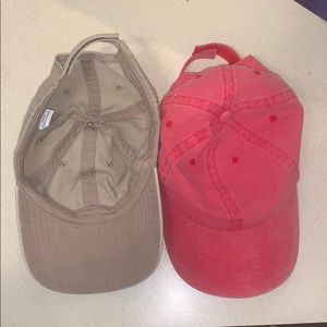 One tan hat, One pinkish red hat.